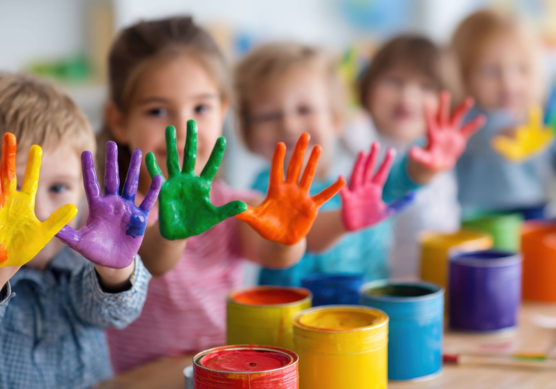 Joyful, diverse children bonding through creative play, reflecting the supportive environment of our Head Start program