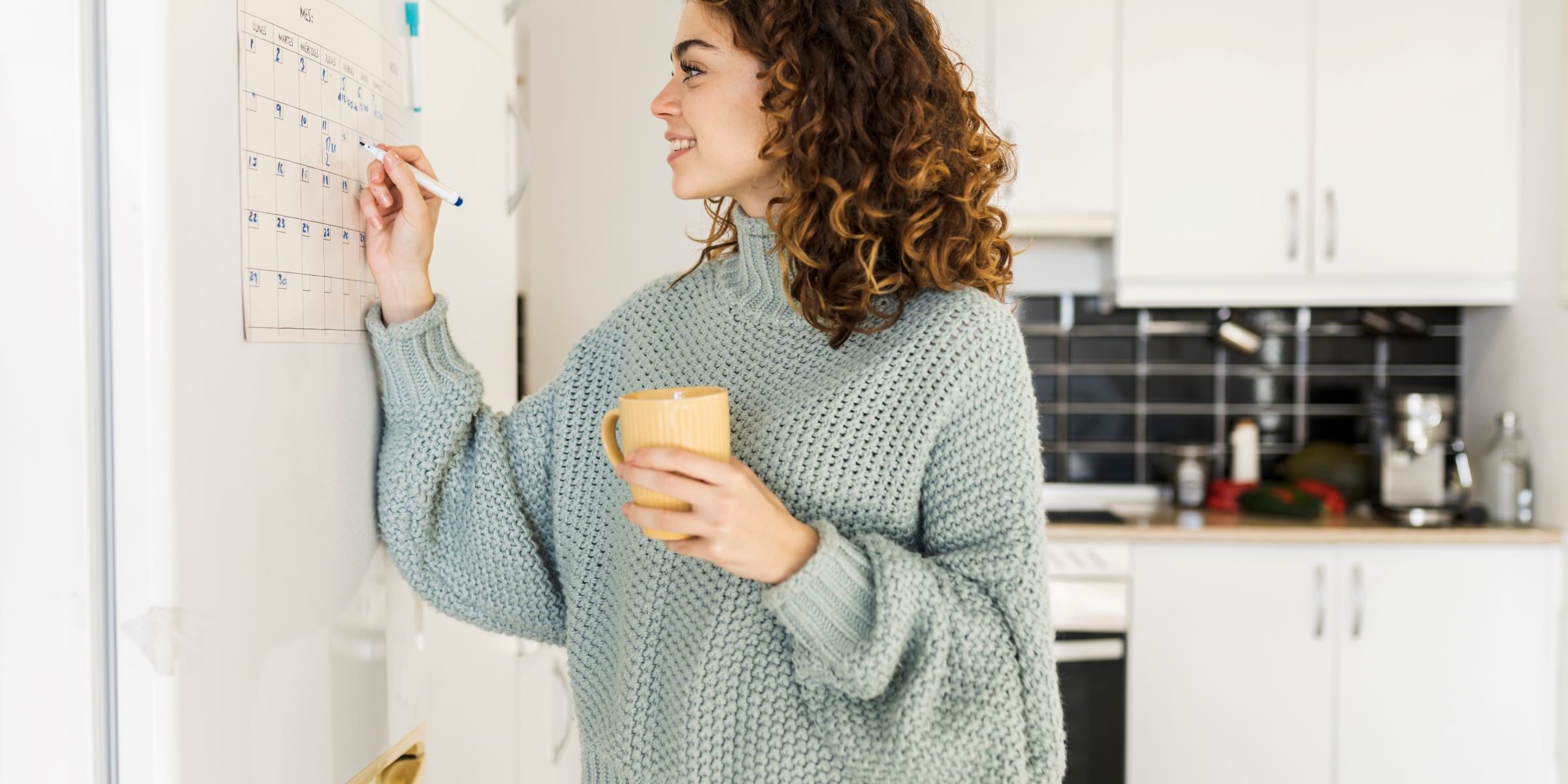 A person updating a calendar on the whiteboard