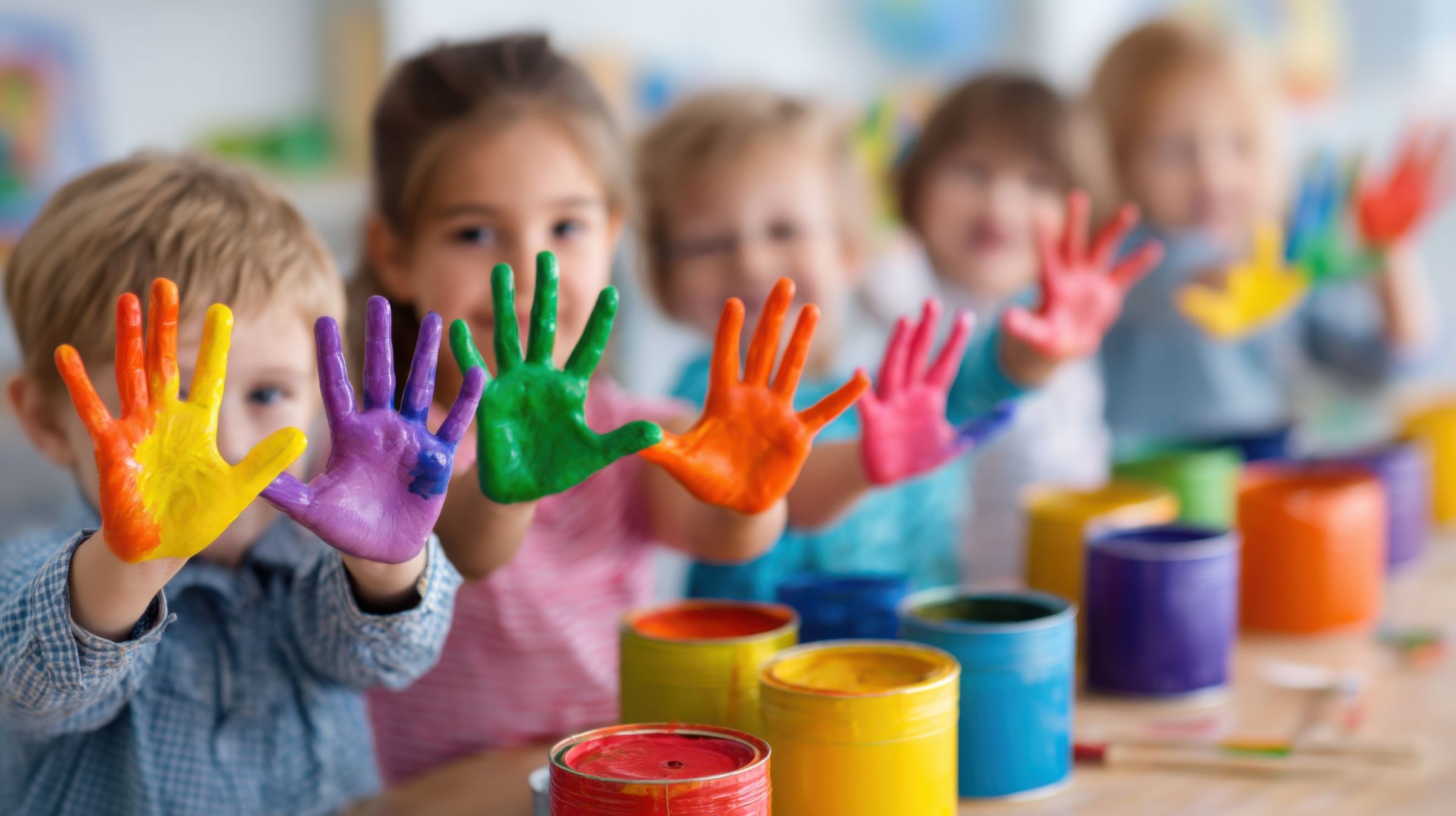 Joyful, diverse children bonding through creative play, reflecting the supportive environment of our Head Start program